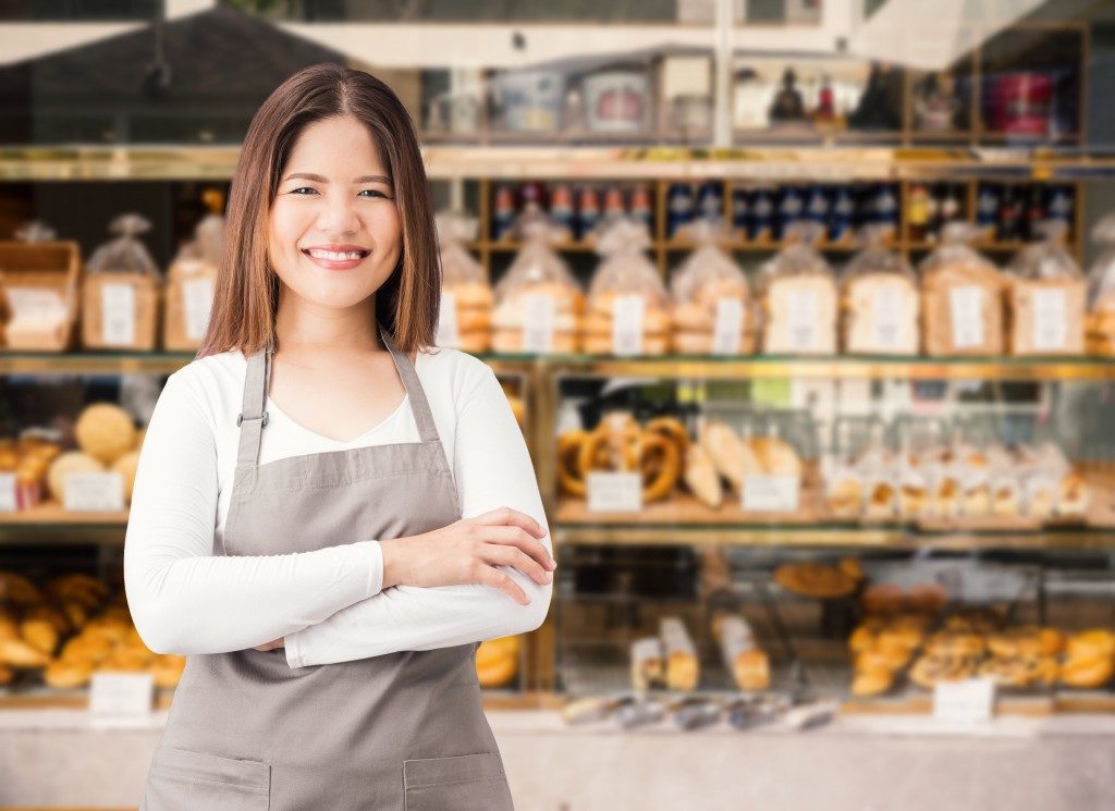 woman smiling at her bakery