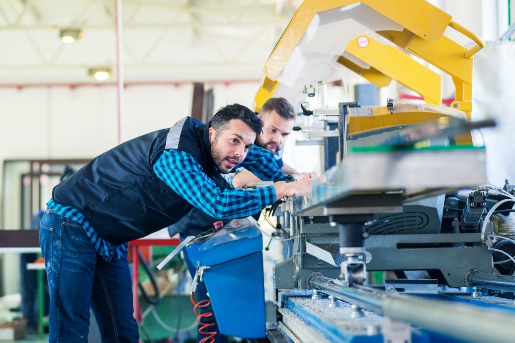two men inside a manufacturing plant