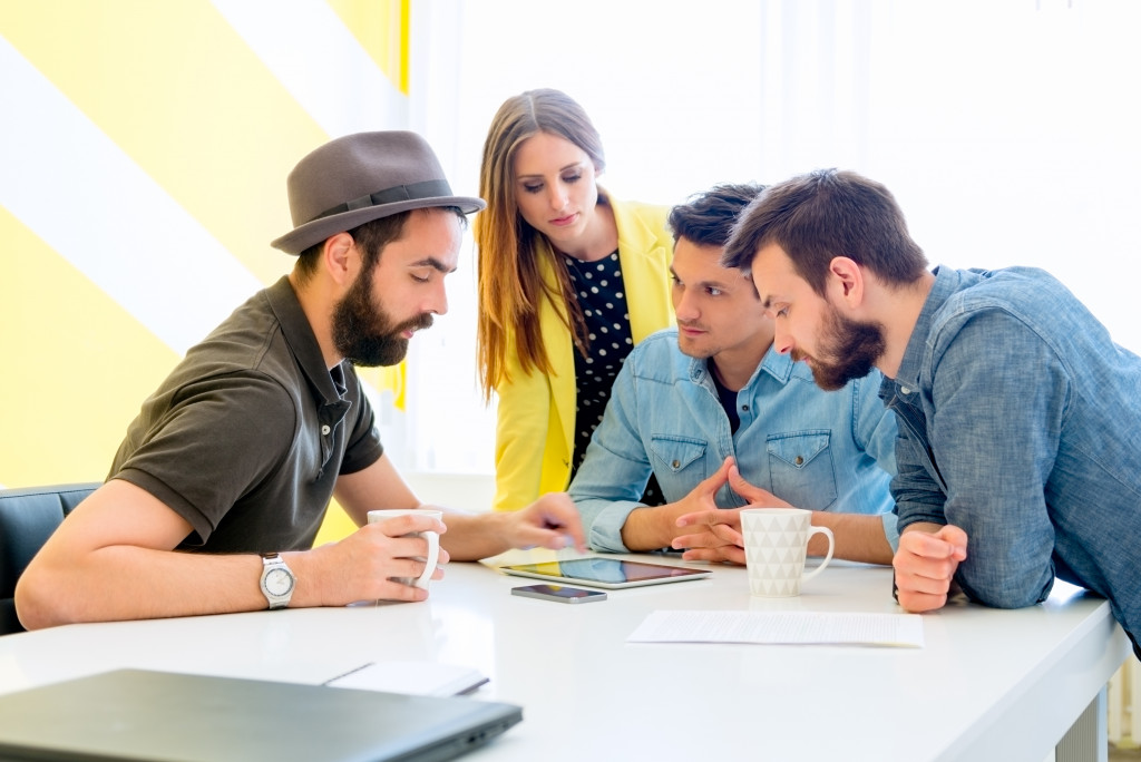 Man explains to colleagues his ideas regarding their work project 