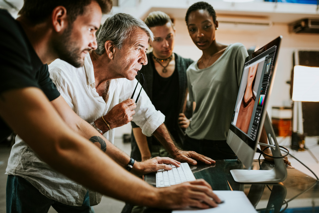 a video team looking at a computer screen for production