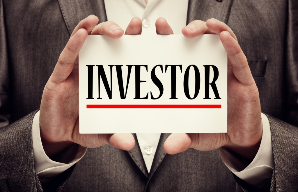 Businessman holding an investor sign