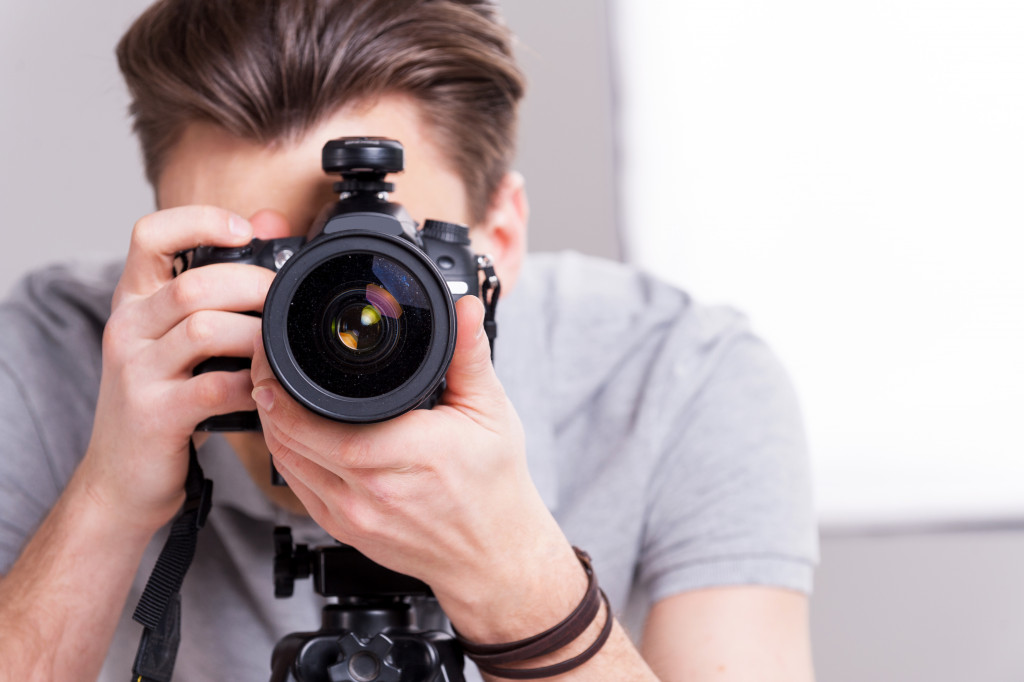 A photographer using his camera