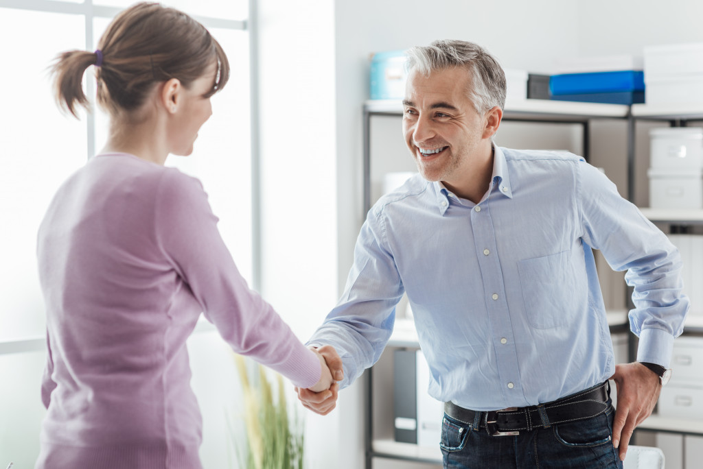 A businessman shaking hands with an applicant