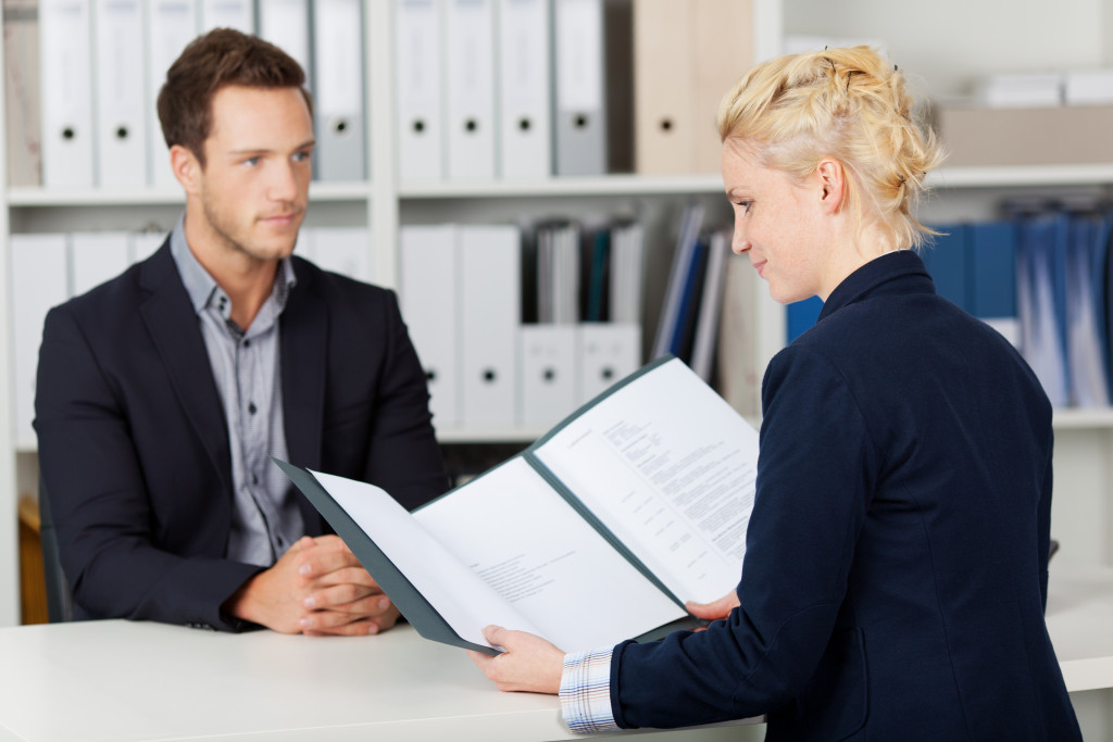 An HR representative reading an applicant's resume