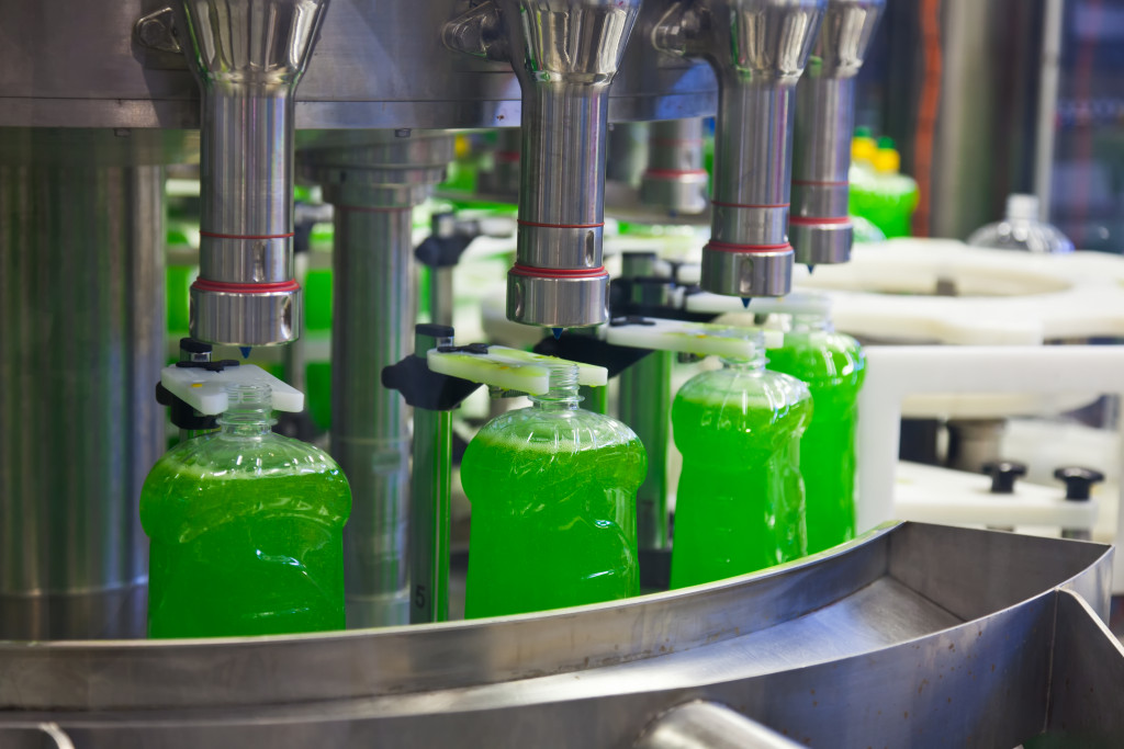 conveyor machine pumping beverages into bottles in a factory