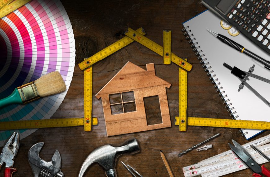Home renovation concept with model house in the center of tools