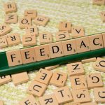 feedback written on small wooden tiles