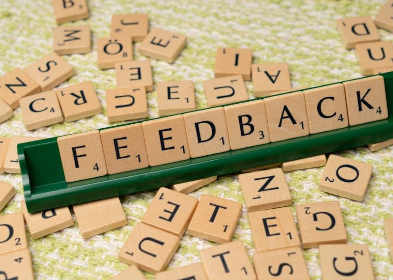 feedback written on small wooden tiles