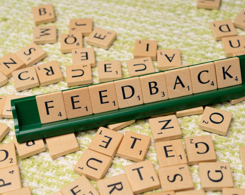 feedback written on small wooden tiles